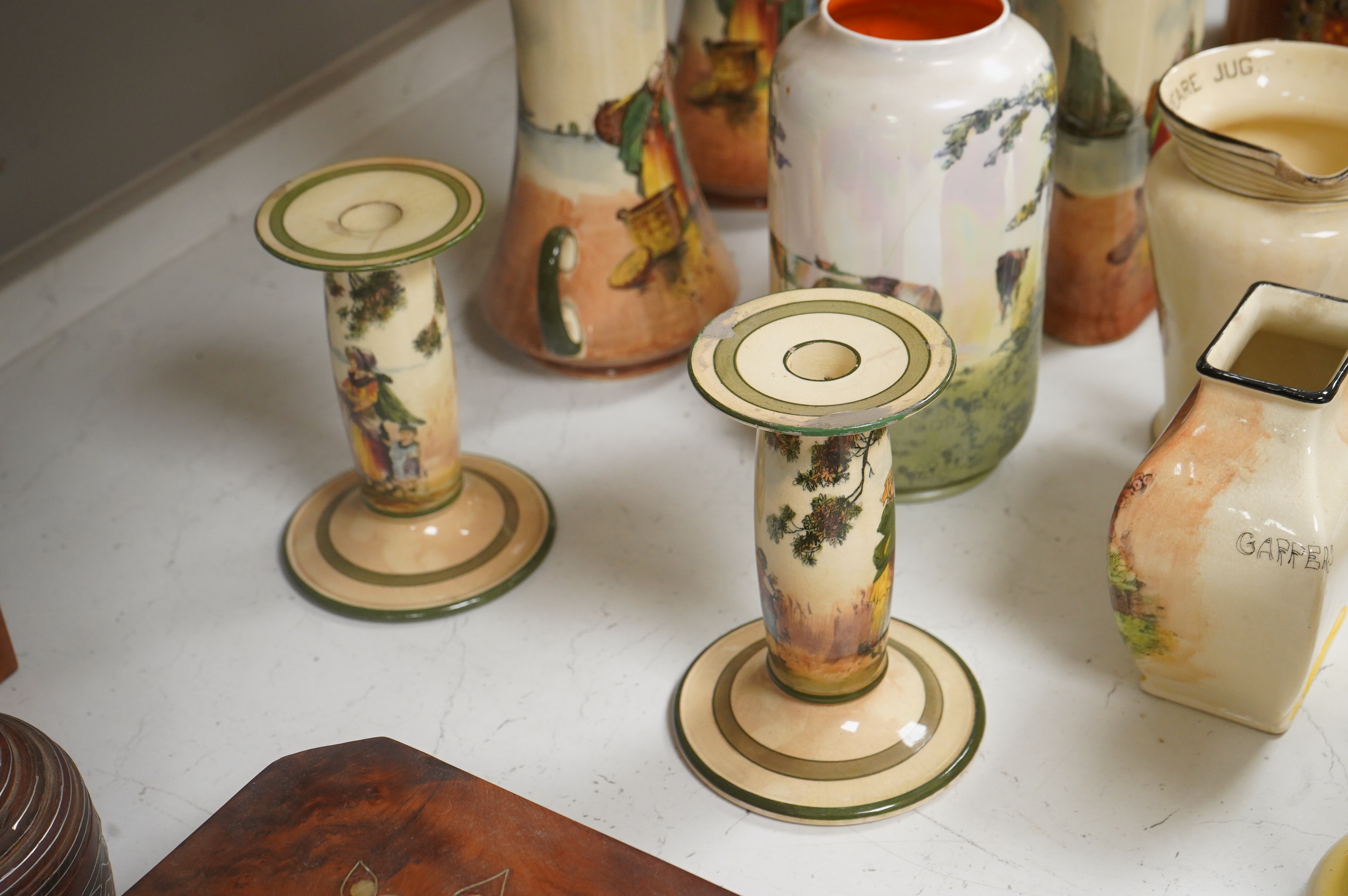 A collection of Royal Doulton series ware jugs, vases and candlesticks, largest 22cm high